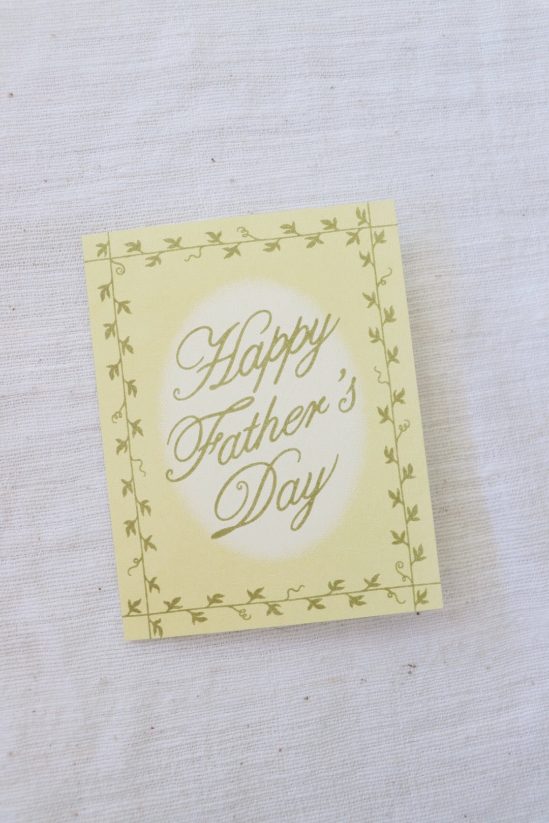 Yellow card with 'Happy Father's Day' text on a textured white background